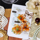 Gold foil floral sticker on journal cover – chic embellishment for personal notebooks.