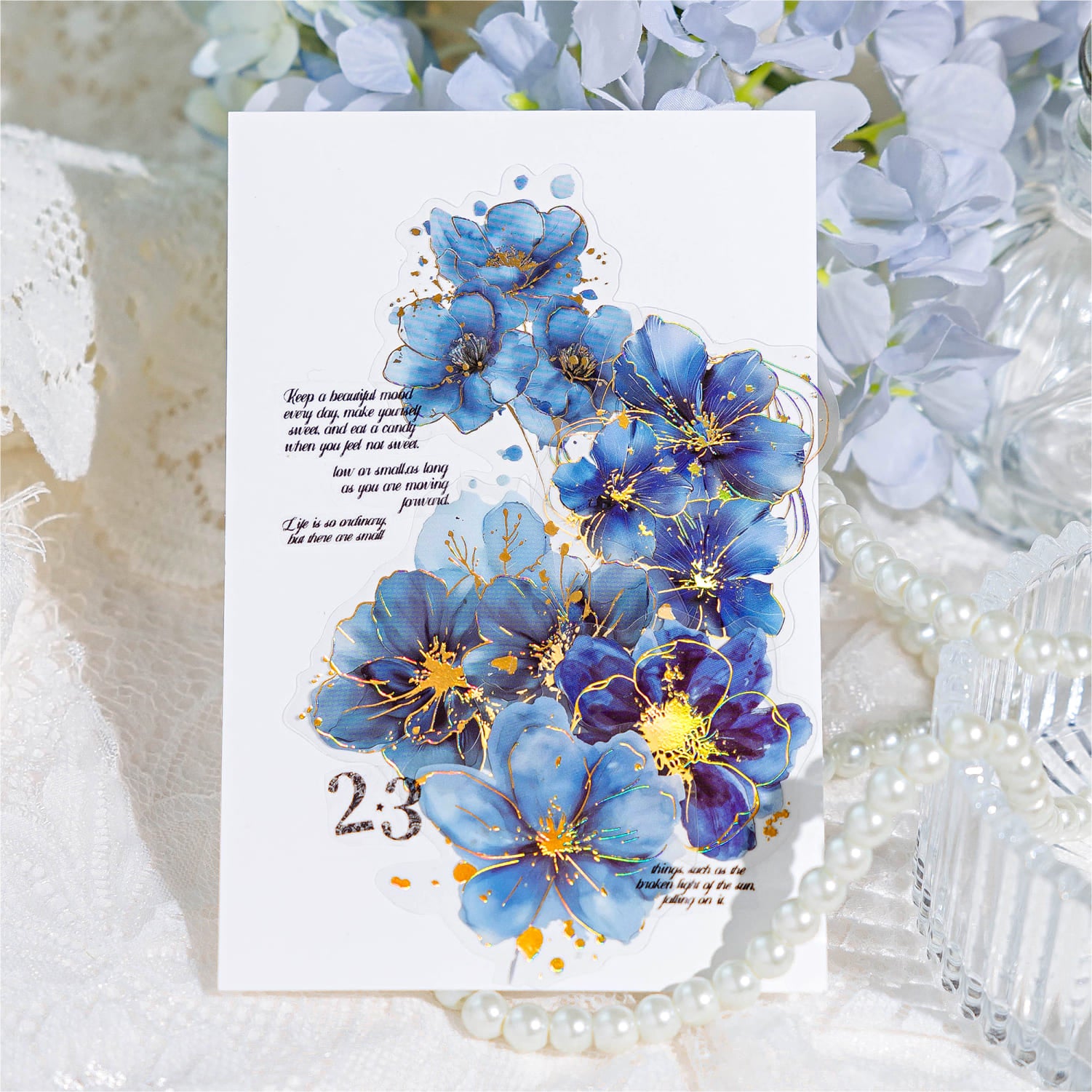 Transparent gold foil floral sticker on planner page – aesthetic decoration for journaling.